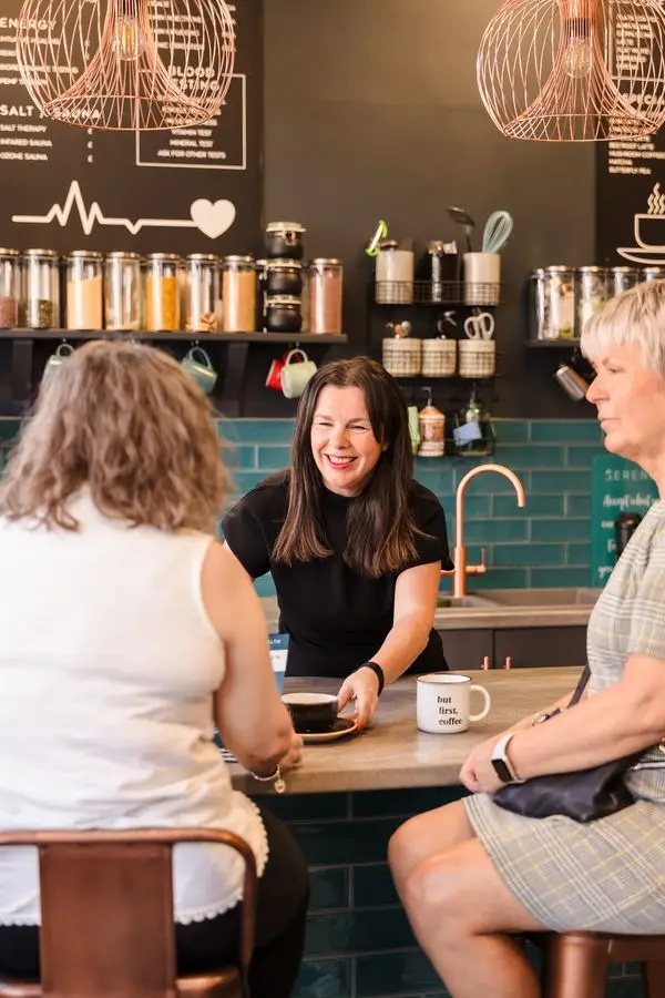 Michelle with clients at the cafe counter