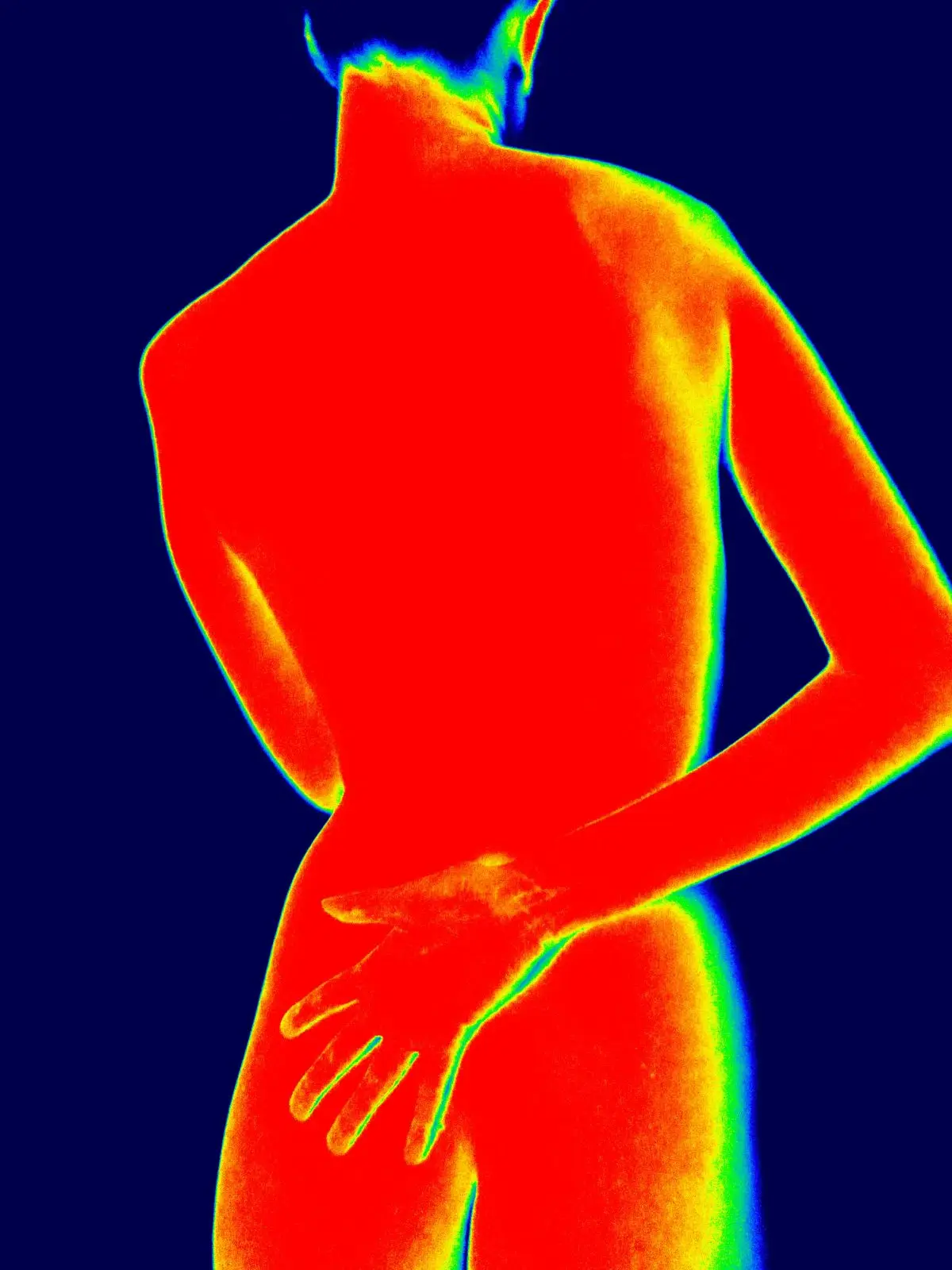 A thermal image showing heat patterns across a back and arm